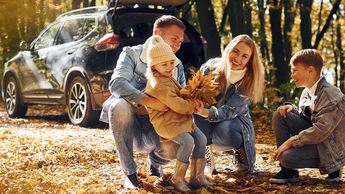 Eine Familie, die im Herbst in einem Wald ist